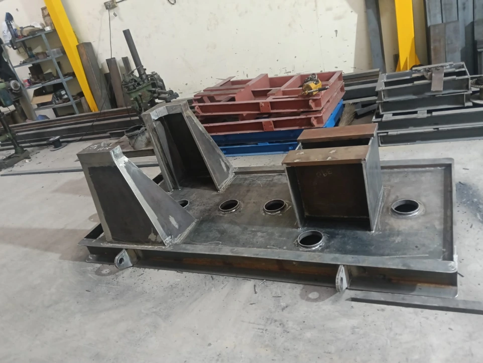 A heavy welded equipment base plate with inclined stiffeners and machined openings, designed to accommodate mechanical equipment and piping supports. Built for strength, alignment accuracy, and long service life under demanding industrial conditions.
